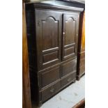 A 19th century oak 2-section cupboard, with fielded panel cupboard doors, and drawers to the base,