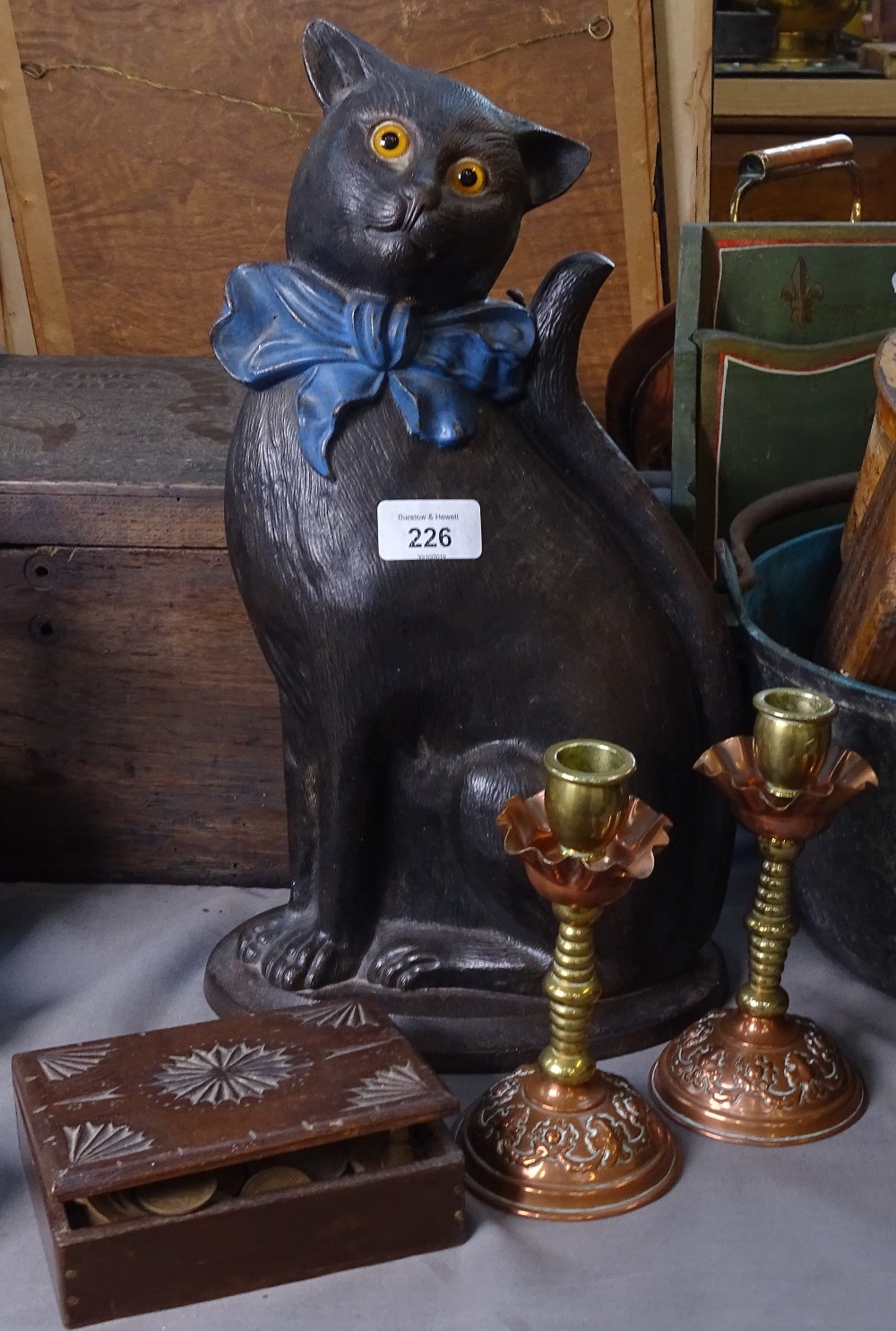 A black cat doorstop with glass eyes, 38cm, candlesticks, and a box of British coins