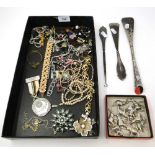 A box containing silver-handled shoe horn, a button hook, an Olympic medal, menu holders, costume