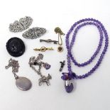 A Centurion carved jet brooch, a silver locket, an amethyst necklace etc