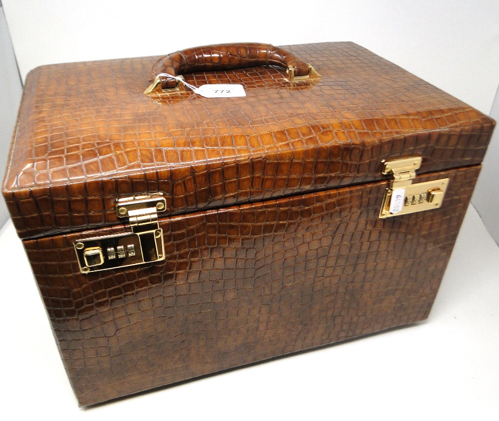 A good quality snakeskin effect travelling jewellery box, with a rising lid revealing a drawer