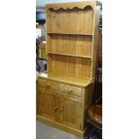 A polished pine 2-section kitchen dresser, W91cm, H200cm