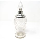 An Art Deco cut-glass and silver-mounted scent bottle