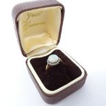 An 18ct gold opal ring, with white stone band, size K