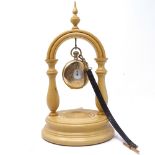 An American Waltham gold plated half hunter pocket watch, on a turned wood pocket watch stand