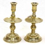 A pair of brass candlesticks with large drip pans, 18.5cm