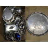 A box containing a large plated circular serving tray, entree dishes, a toast rack, teaware etc