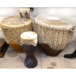 A Tribal skin-covered drum, height 43cm, and 3 smaller drums