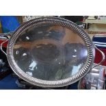 A large oval silver plated 2-handled serving tray, with gadrooned edge and engraved decoration,