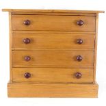 A table-top pine chest of 4 drawers, height 30cm