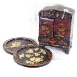 A pair of Japanese lacquered wall plaques with applied shell decoration, and an Oriental table-top