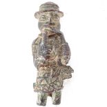 A patinated bronze Ethnic figure wearing a hat and holding tools, 13cm