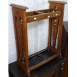 An Arts and Crafts oak stick stand, with stylised pierced sides, W54cm, H71cm