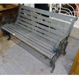 A painted slatted scrolled garden bench, on wrought-iron ends