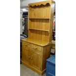 A polished pine 2-section kitchen dresser, W91cm, H200cm