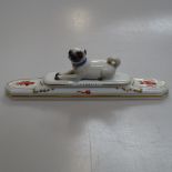 A Meissen desk weight surmounted by a Pug dog, length 20.5cm