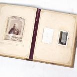 A Victorian gilded leather-bound family photograph album, with musical movement, height 29.5cm