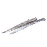 An Eastern dagger with white metal hilt and embossed white metal scabbard, length 44cm