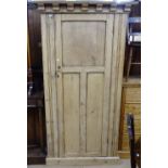 A polished and panelled pine hall cupboard with single door, W105cm, H190cm