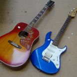 An acoustic guitar, and a Pacifica Yamaha guitar