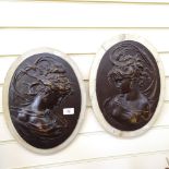 A pair of bronzed embossed wall plaques, 36cm