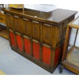 A reproduction oak corner bar, with carved panels, W122cm, D72cm, H97cm