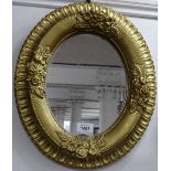 An oval gilt-framed wall mirror, W34cm