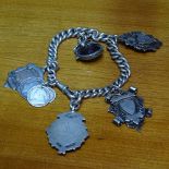 A silver bracelet set with silver charms, and swivel fob