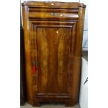 A 19th century walnut corner cupboard, with ogee frieze drawer above a panelled cupboard door, on