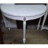 A white painted demilune console table with fluted legs, W91cm, H75cm