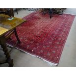 A large red ground Afghan carpet, symmetrical pattern, 290cm x 205cm