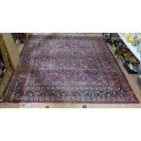 A large red ground Persian wool carpet with symmetrical pattern and border, 370cm x 270cm