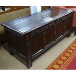 An 18th century oak coffer, with chip carved panelled front, on stile legs, W143cm, H63cm