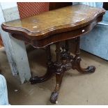 A Victorian burr-walnut topped serpentine fold over card table, raised on a carved quadruple