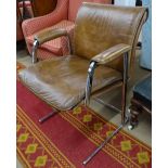A brown leather upholstered and chrome cantilever desk chair