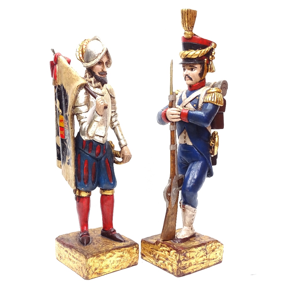 A pair of Continental carved and painted wood soldier figures on plinths, tallest 55cm