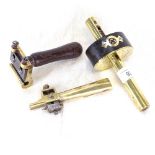 A brass-mounted peg cutter, brass purfling channel cutter, and a brass-mounted mortice gauge