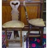 A pair of Arts and Crafts oak tripod chairs