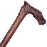 An Oriental walking stick with carved horse-head handle and mask decoration, length 92cm