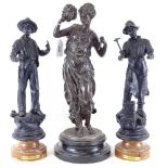 A pair of French spelter tradesman figures, and another - lady holding a mask, height 43.5cm