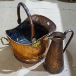 A copper coal bucket with swing handle, and a copper jug