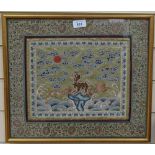 An embroidered Chinese silk panel with floral surround, framed, height 39cm