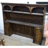 An Antique oak plate rack, with panelled back fitted with open shelves and cupboards, W160cm,