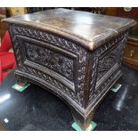 A 1920s oak concave coffer of small size, with carved panelled front, on bracket feet, W56cm, H44cm