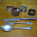 4 silver napkin rings, an engraved silver fork and spoon and knife set