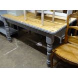 A rectangular polished and painted pine kitchen table, on baluster legs, L152cm