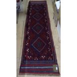 A Meshwani red ground runner, 235cm x 61cm