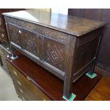 An 18th century joined oak coffer, with chip carved panelled front, on stile legs, W110cm, H62cm