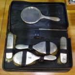 A George V 5-piece engraved silver dressing table brush and mirror set, cased, Birmingham 1936