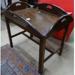 A mahogany folding butler's tray on stand